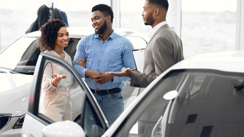 Couple car shopping at a dealership