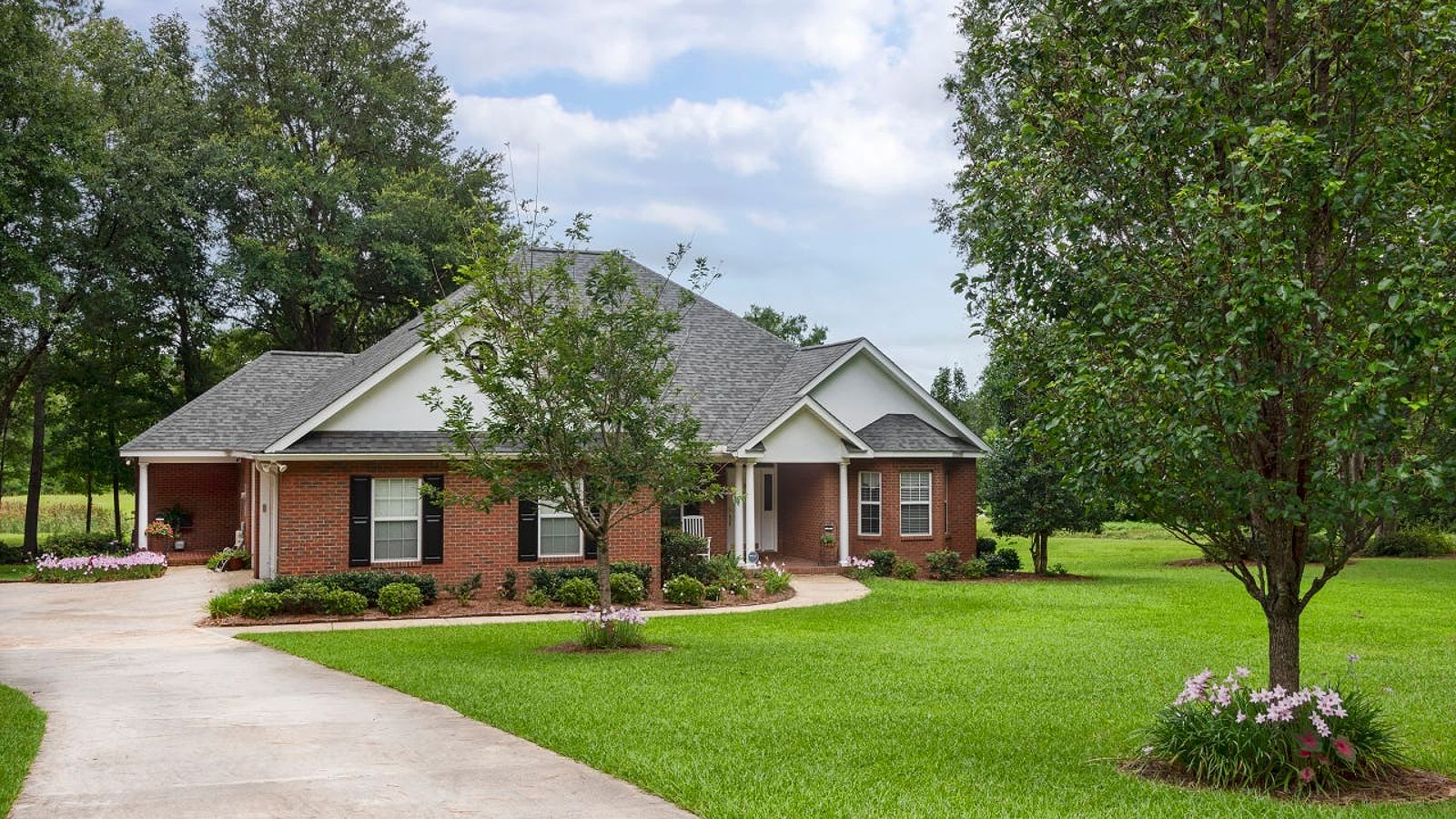 Traditional style brick house with black shutters